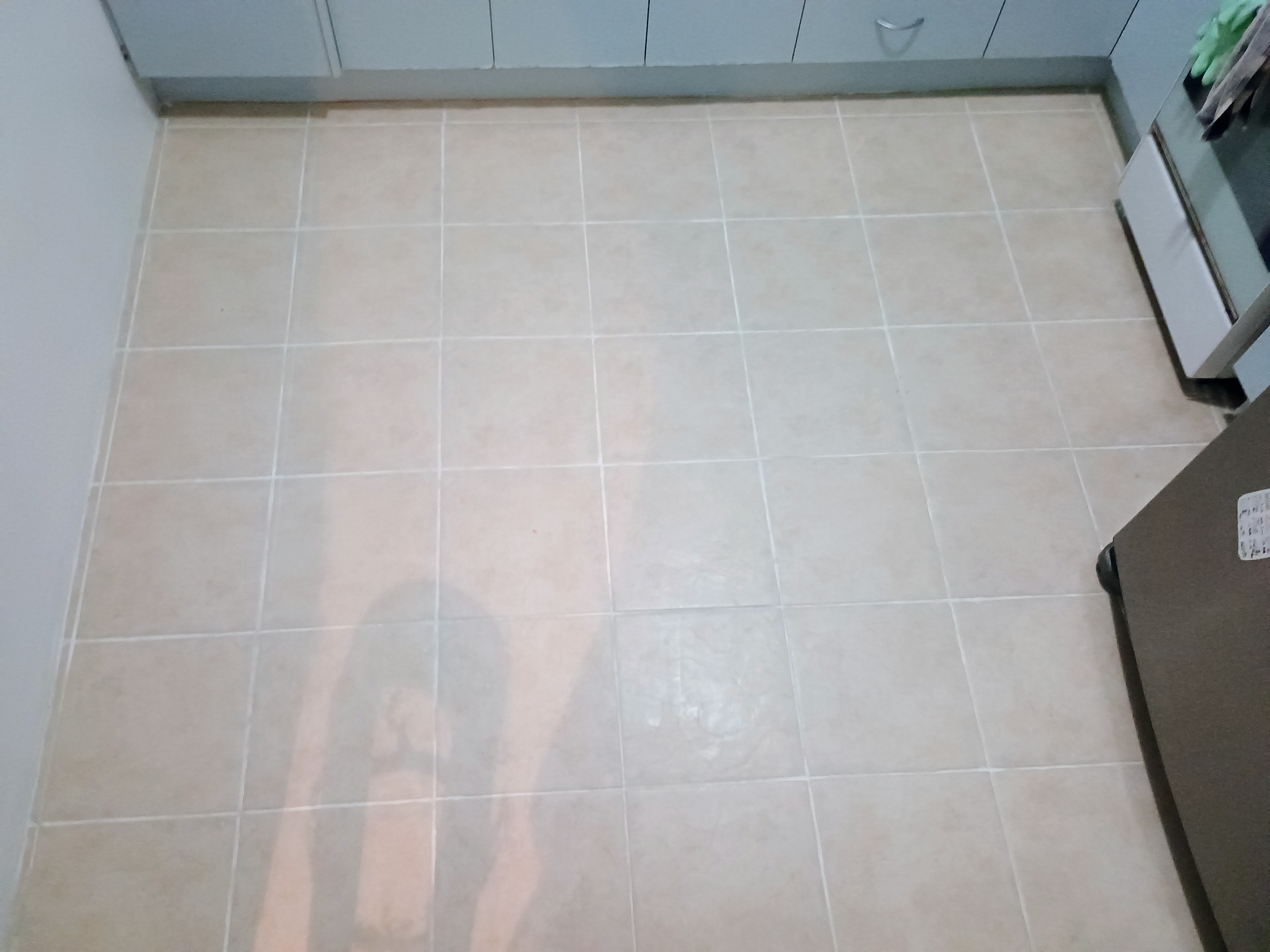 Wide view of a kitchen floor after grout colour restoration