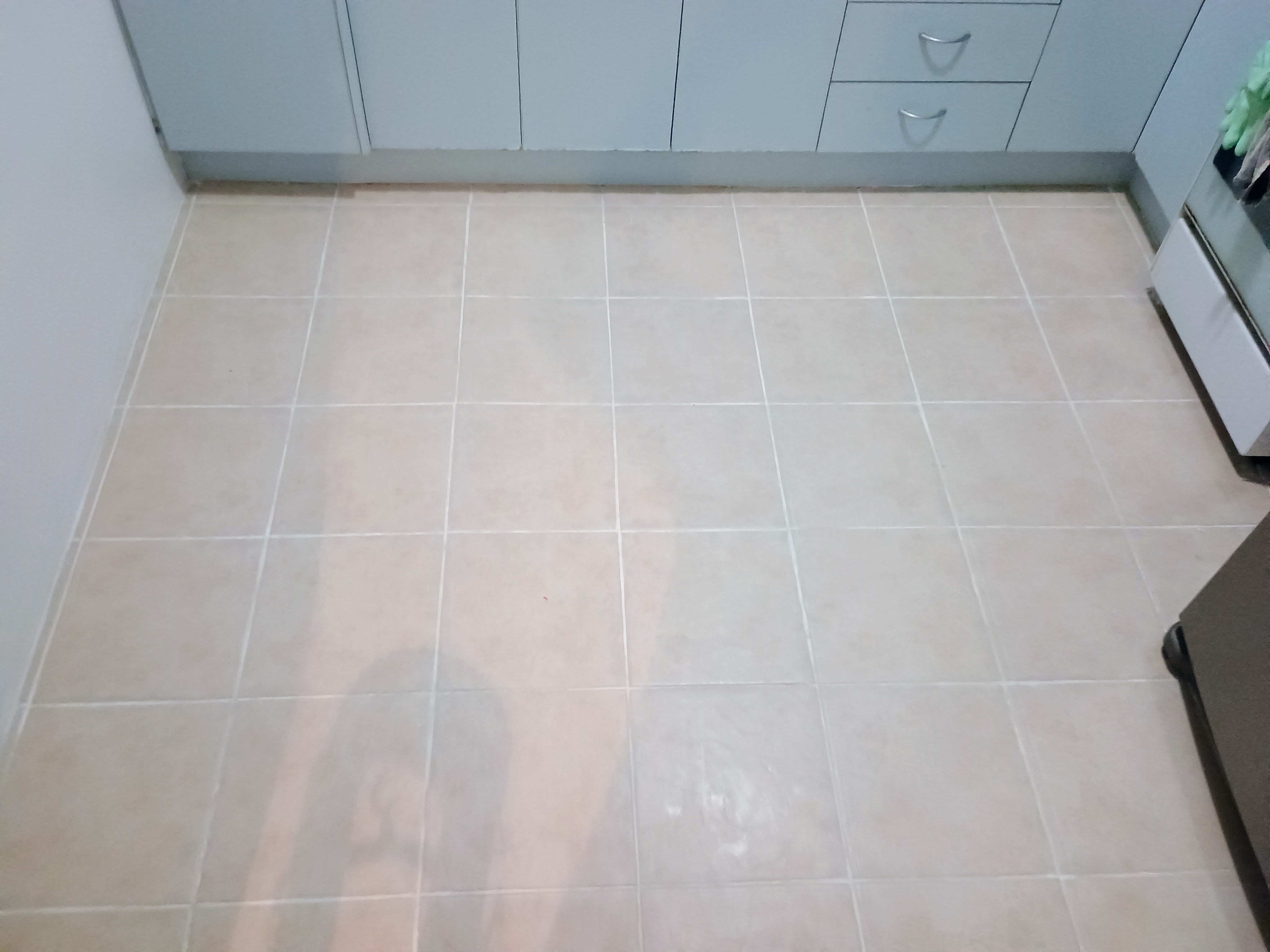 Closer view of clean and even grout lines on the restored kitchen floor