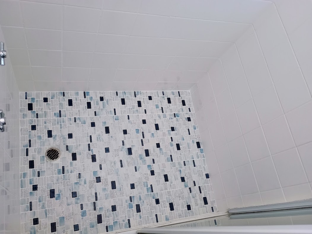 Wide view of the finished shower and its restored grout lines